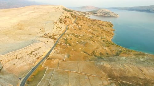 Aerial view of road through desert landscape of Pag island in Croatia
