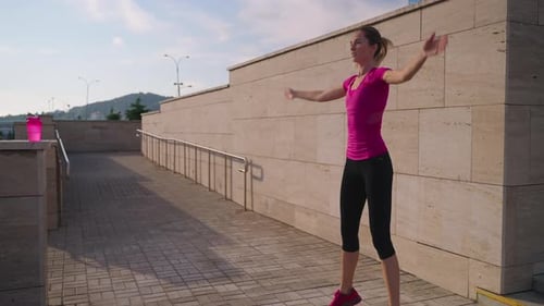 Athletic Woman Doing Jumping Jacks Outdoors