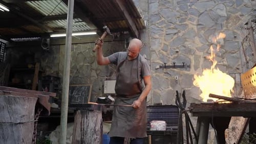 Blacksmith Forging Metal in a Traditional Workshop