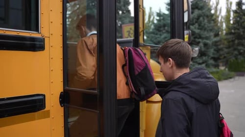 School Bus Opening Doors for High School Students