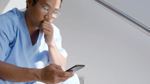 Adult Doctor Using Phone in Hospital Close Up