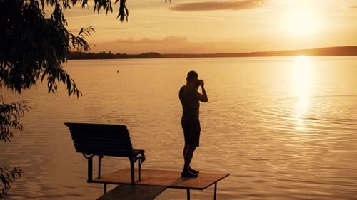 Photographer Taking Picture of Sunset