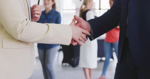 Business People Handshake in Bright Office