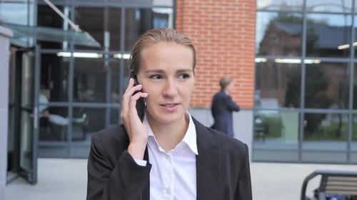 Woman in Business Suit Talking on Phone