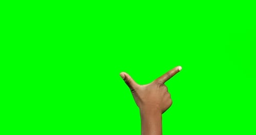 Person making hand gesture against green screen background