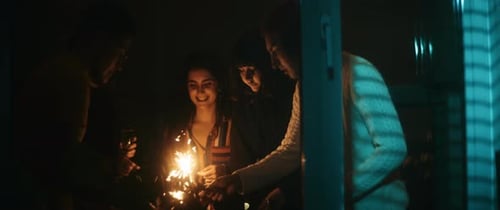 Friends celebrating new years eve with shiny sparkler