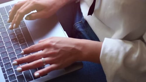Female Hands Are Typing on the Keyboard