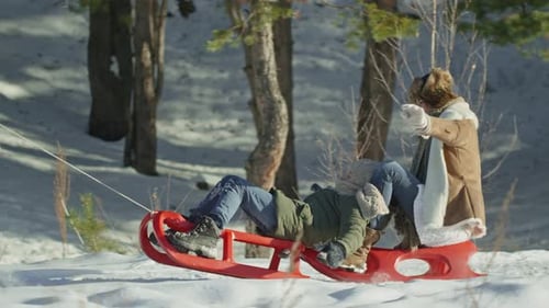 Man Pulling Sled in Winter