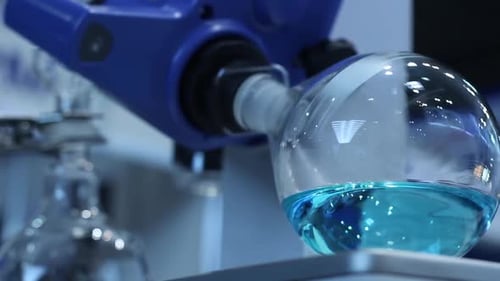 Rotating Flask with Blue Liquid in Lab Equipment