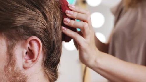 Female Hairdresser Making Haircut to Man in Beauty Salon Slow Motion Close Up