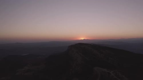 Sunset sky over mountain ridge in highland
