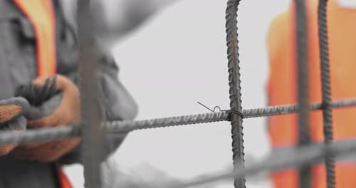Engineers Work with Metal Constructions While Building a House