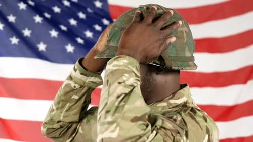 Young Soldier Adjusting Helmet with American Flag