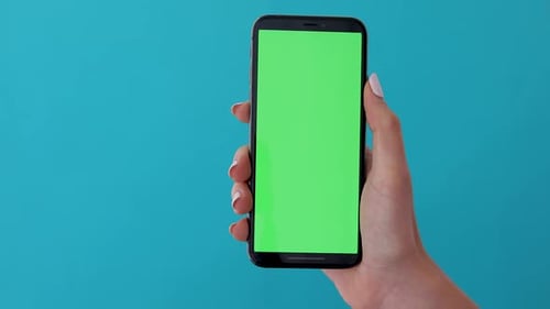 Hand Holding Smartphone With Green Screen