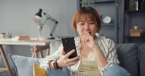 Woman Enjoying Video Call at Home on Sofa