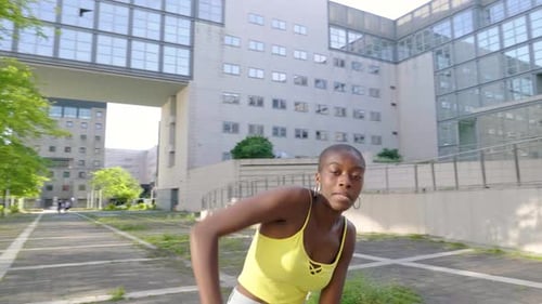 Energetic Woman Dances on Urban Plaza