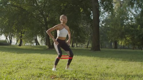 Athletic Woman Doing Squats in Green Park