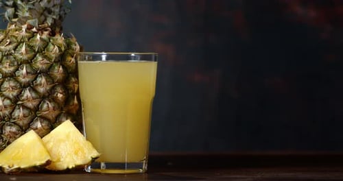 L'ananas frais et le jus d'ananas pivotent lentement
