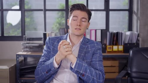 Man in Blazer Gesturing in Office Environment