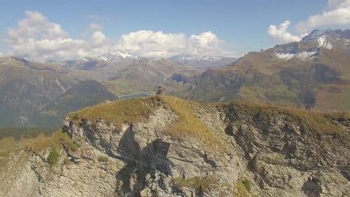 Aerial drone view of mountain biker biking in the mountains.
