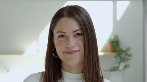 Closeup Portrait Smiling Spanish Woman at Camera in an Office or Apartment