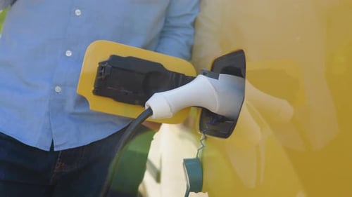 Charging Electric Vehicle Close Up in Daytime