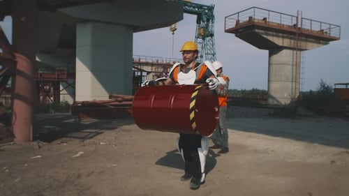 Construction Worker Carrying Barrel in Exoskeleton Suit