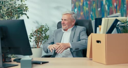 Gray Haired Business Man Talking to Computer