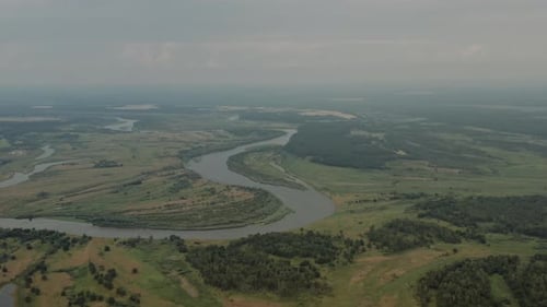 Aerial Landscape, Drone Flies High Over Beautiful Winding River Flows Through Green Meadows, Wheat