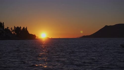 Vibrant Sunlight Over Seascape With Sailing Boat During Dusk. Wide Shot