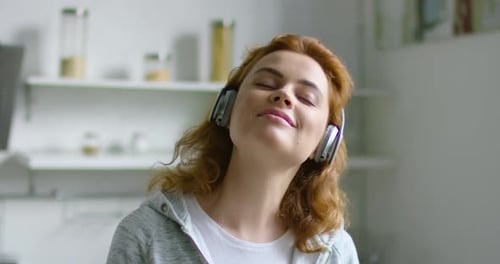 Young Woman Listening to Music at Home