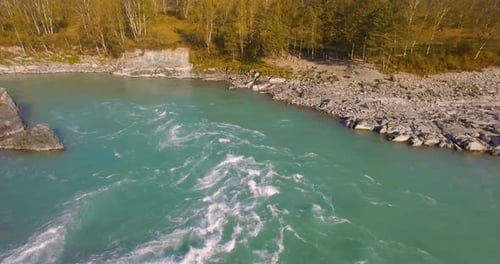 Low Altitude Flight Over Fresh Fast Mountain River with Rocks at Sunny Summer Morning.