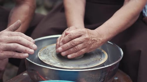 Close Up Hands Make Pitchers in Pottery