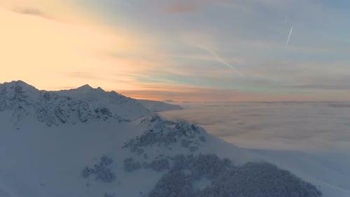 Mountain Peak Revealing a Foggy Valley and the Sky in Sunset Colors