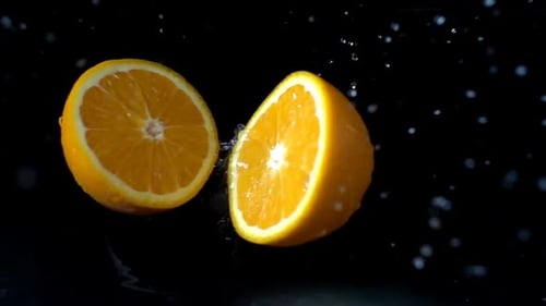 Orange Sliced in Half in Slow Motion Splash