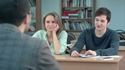Students Attentively Listening To Male Teacher and Communicating in the Classroom