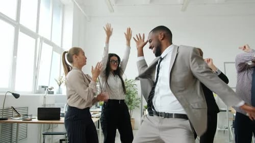 Colleagues Celebrating Success With Energetic Dance