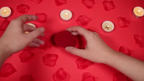 Hands Reveal Engagement Ring with Candles and Petals