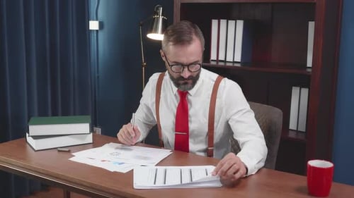 Senior business man inspecting statistics of report financial at home office.