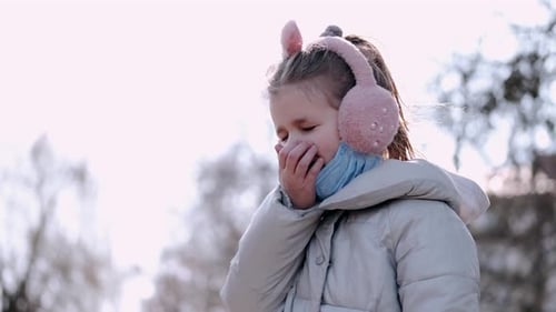The Kid in Winter Headphones and a Mask Is Coughing Outside
