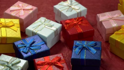Colorful Gift Boxes with Ribbons on Red Background