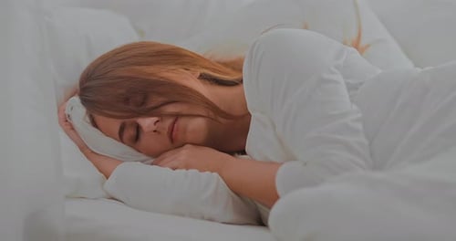 Woman Sleeping Peacefully in Bed at Home
