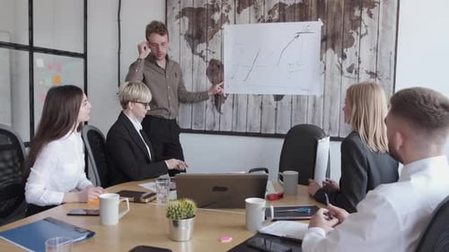 Business Team Discussing Charts and Graphs in Office