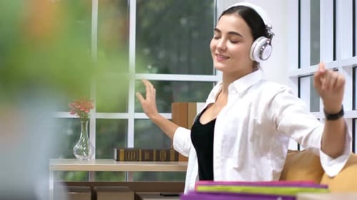 Young Woman Enjoying Music with Headphones at Home