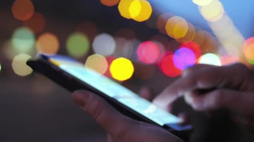 Texting Sms on Background of City and Transport Lights