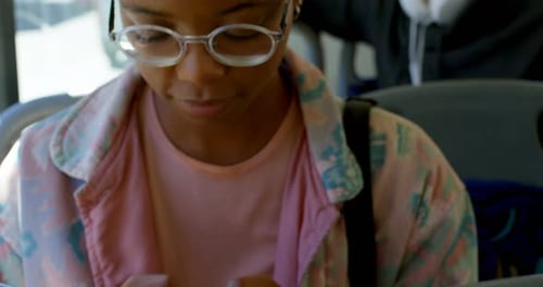 Young Adult Using Mobile Phone on Bus