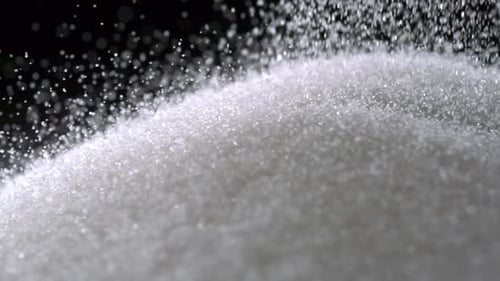 Pile of sugar on black background, Slow Motion