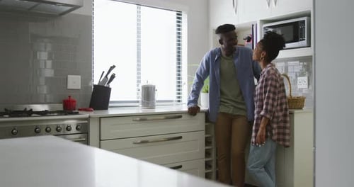Happy Couple Embraces in Modern Kitchen