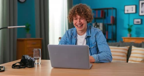 Successful Teenage Boy Sits at Table Uses Laptop Read Emails Online Home Office Gets Good