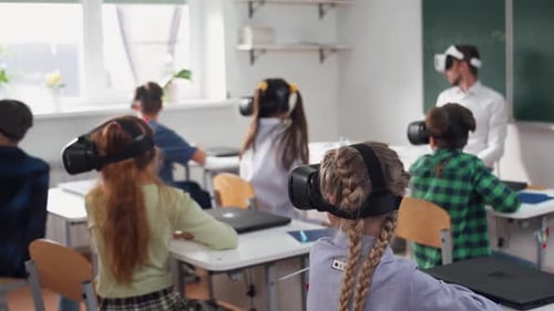 Teacher Teaches an Interactive Lesson at Modern School Childs in Virtual Reality Glasses Learning in